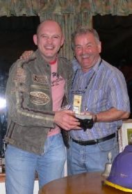 Ram Jam picking up the Hamlet Trophy from Veteran Golfer Andy McGinn